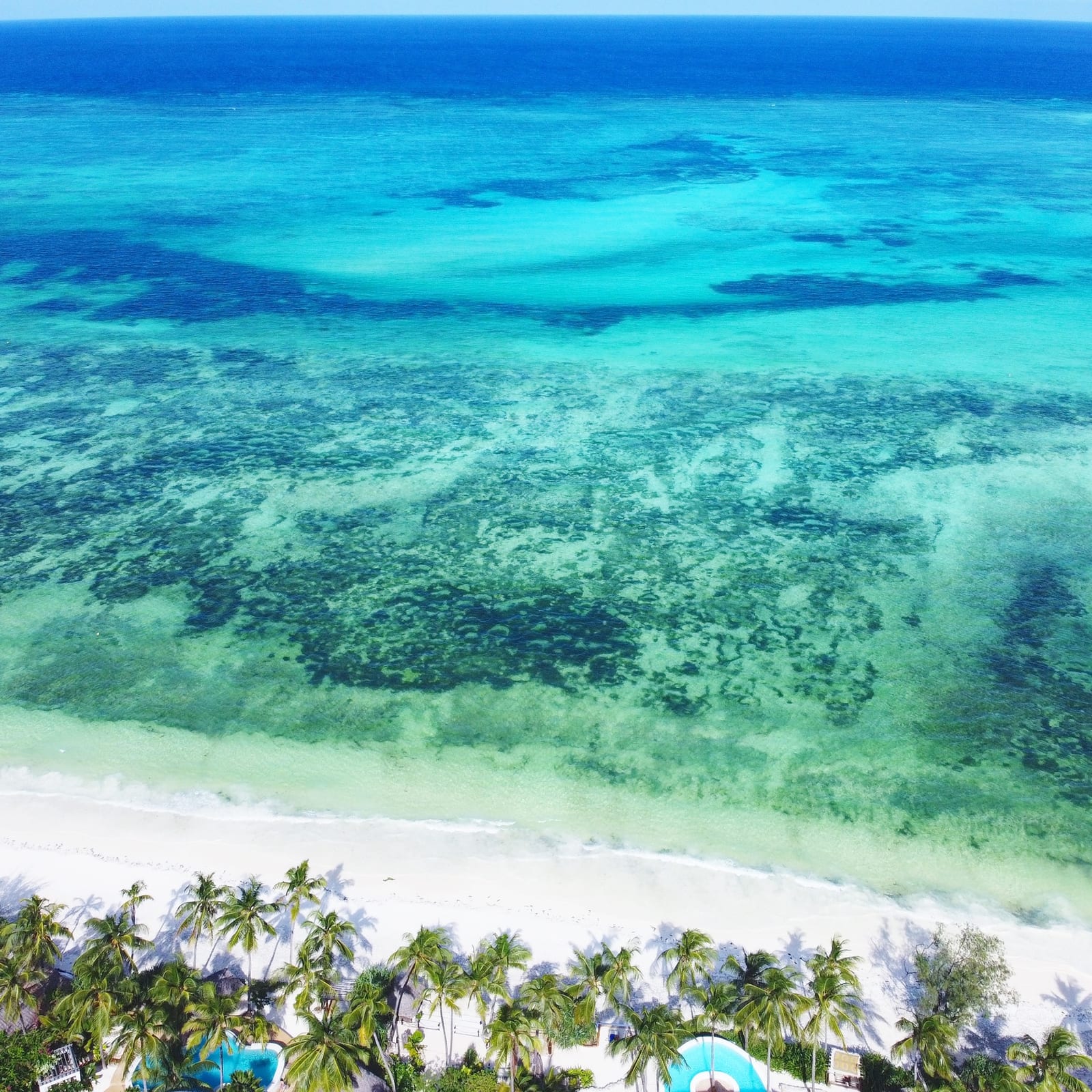 Both houses from the air, with the beach in front