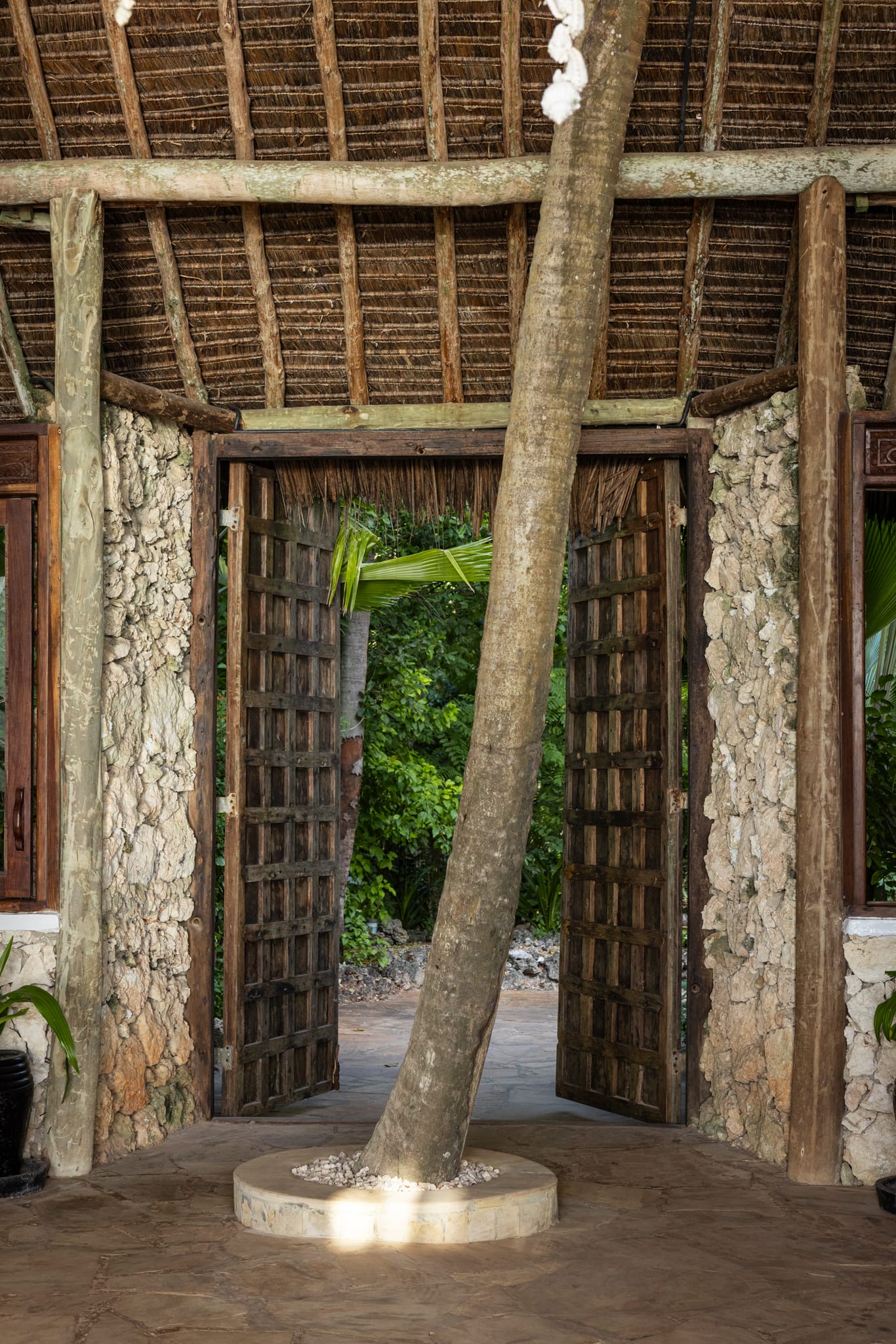 The carved wooden entrance door of Asili House