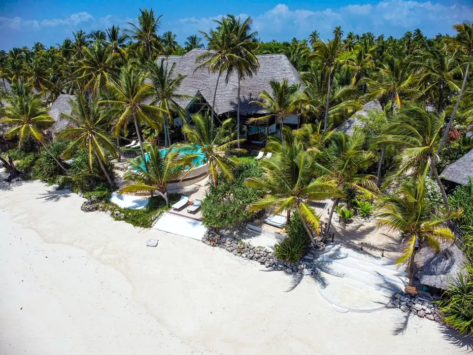 Drone view of Asili House hidden among coconut trees with Michamvi Pingwe beach at Boutique Hotel Matlai Zanzibar.