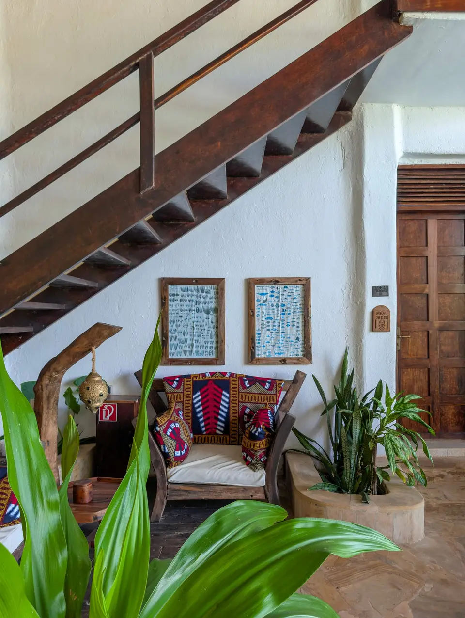 Lounge corner at Asili House, Boutique Hotel Matlai Zanzibar, with two handcrafted dhow sofas for reading and relaxing.