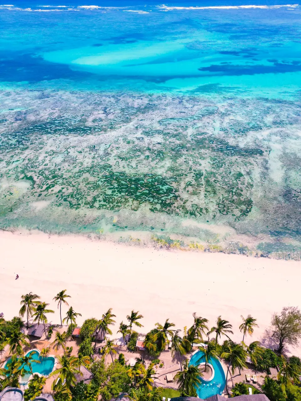 Drone view of Asili House and Villa Kidosho at Boutique Hotel Matlai Zanzibar, with beach and ocean.
