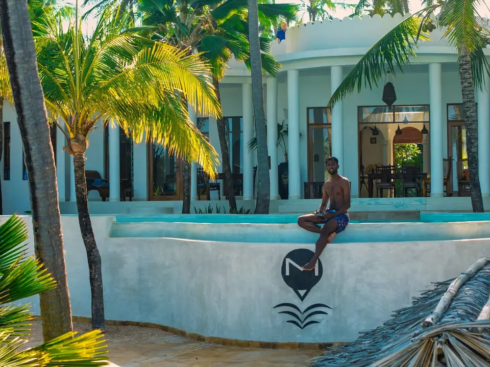 Guest at Pool Edge – Villa Kidosho Zanzibar