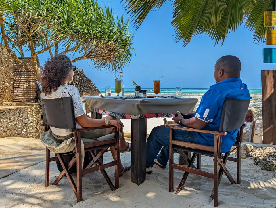 Beachfront dining table at Zatiny Restaurant, Boutique Hotel Matlai Zanzibar, overlooking the Indian Ocean and the Matlai Mchanga Sandbank.