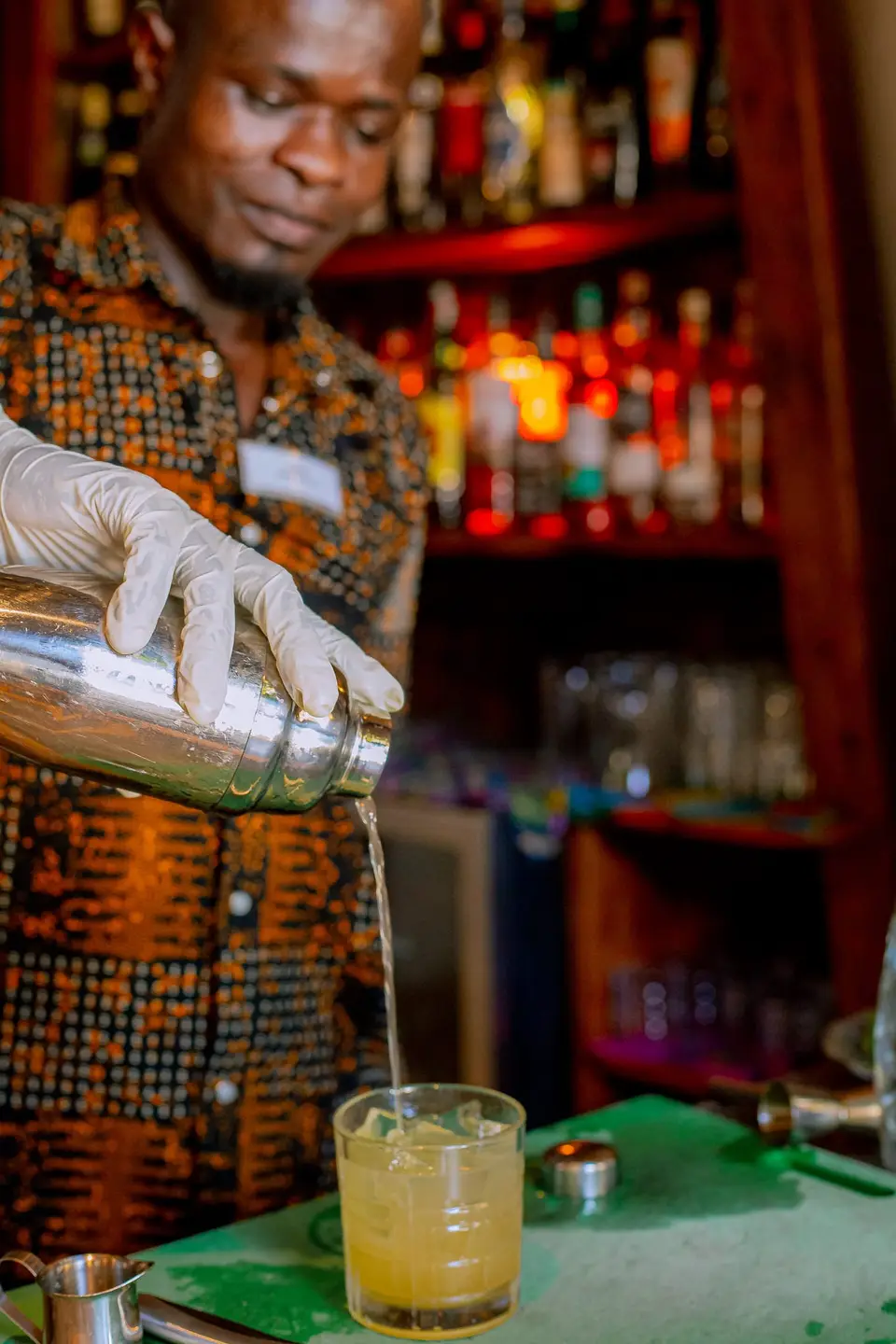 Barkeeper Julius preparing a signature cocktail at Zatiny Restaurant, Boutique Hotel Matlai Zanzibar.