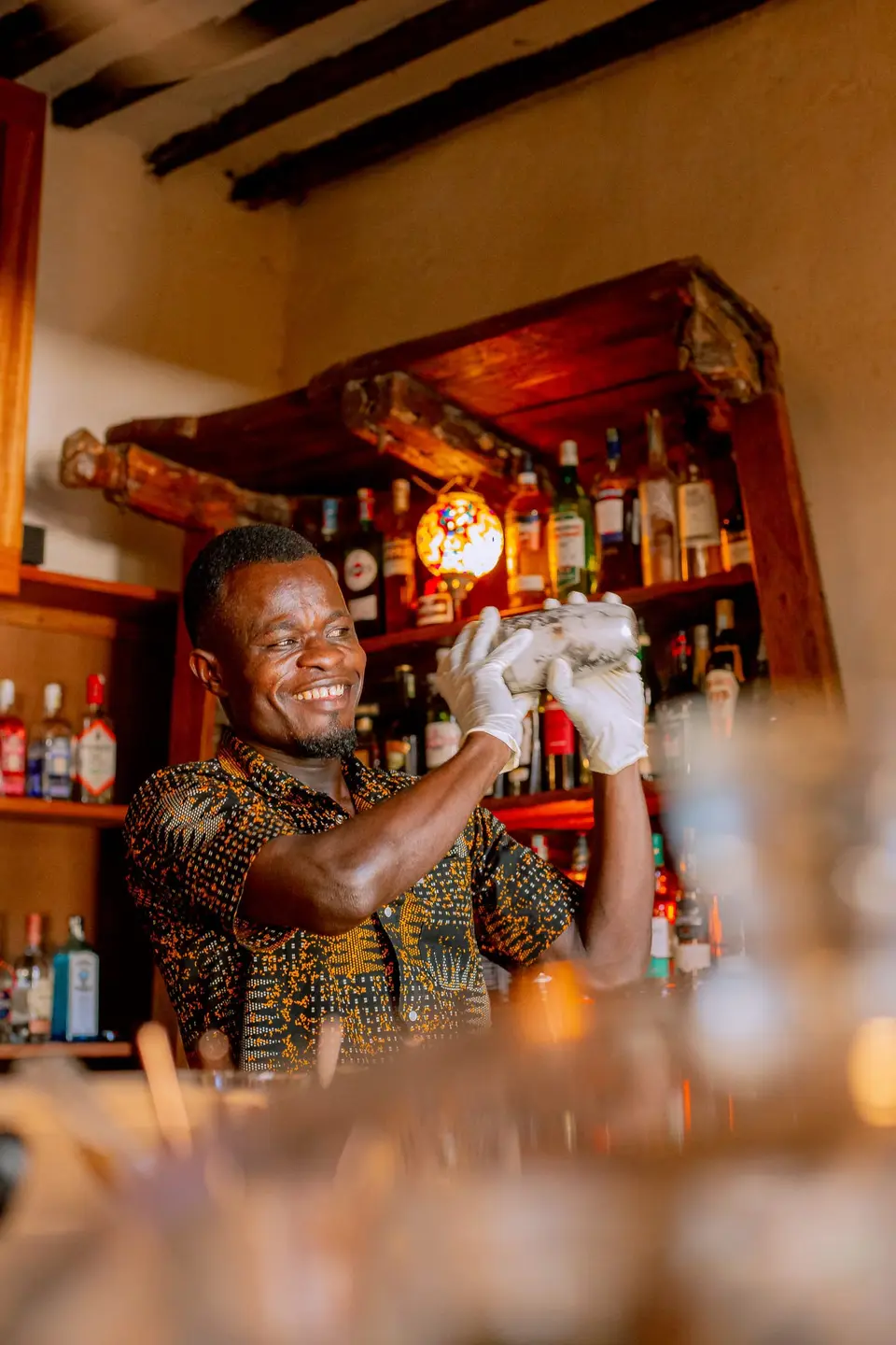Barkeeper Julius shaking a cocktail at Zatiny Restaurant, Boutique Hotel Matlai Zanzibar.