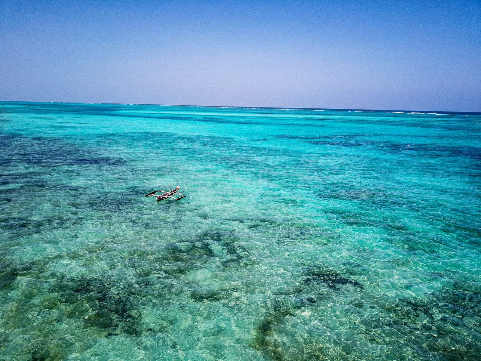 Traditional fishing boat on clear turquoise water off the east coast