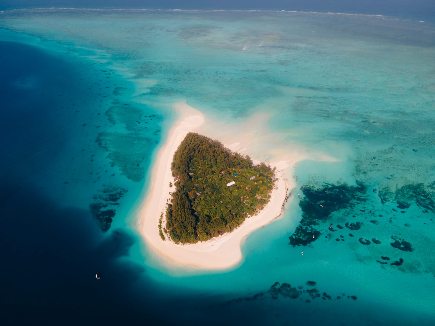 Aerial view of a Zanzibar archipelago island ringed by turquoise shallows